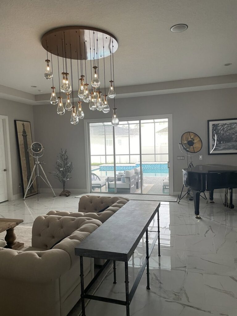 Elegant living room featuring a large, multi-bulb chandelier installed by Heck Electric, LLC in Everett, WA