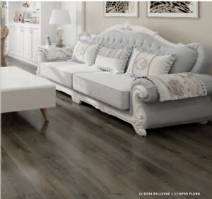 A living room featuring dark wood-look flooring, a completed project by Carpet Planet LLC in Colorado Springs, CO.