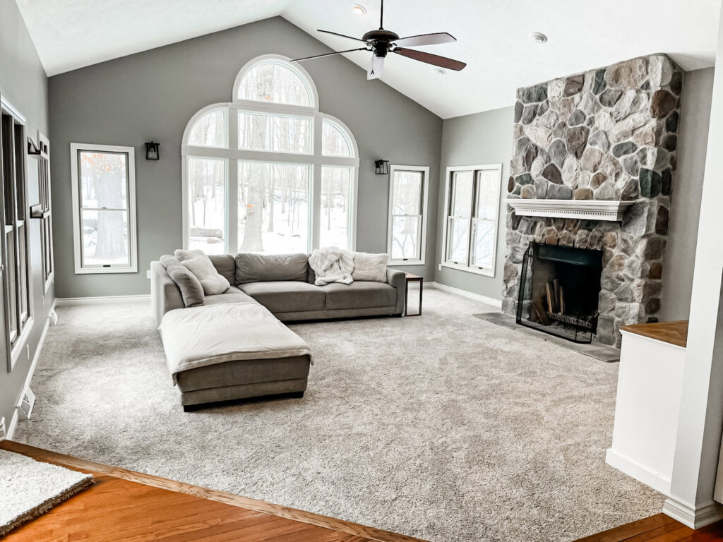 A comfortable living room showcasing a new grey carpet installation by Absolute Floor Covering, Inc in Kentwood, MI.