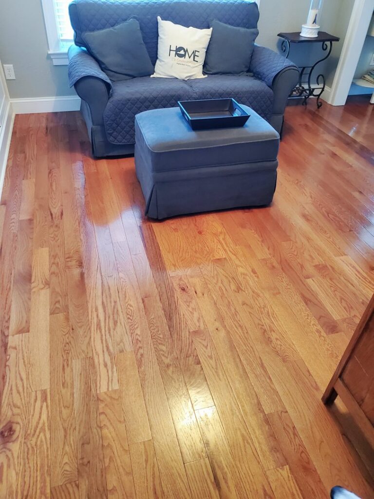 A cozy living room with a new hardwood flooring installation by VA Carpet Connection LLC in Chesapeake, VA.