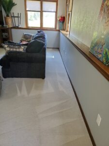 A living room with light-colored carpet showing fresh cleaning patterns from Pueblo's Best Carpet & Air Duct Cleaning in Pueblo West, CO.