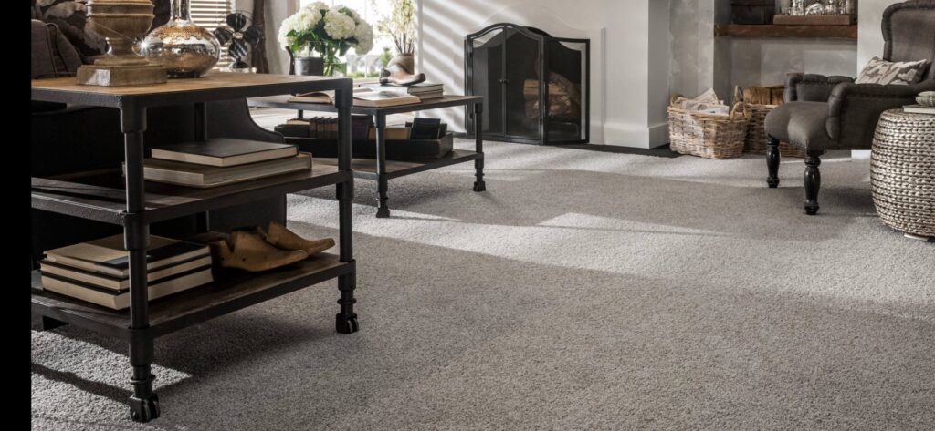 A spacious living room featuring newly installed light grey carpet by Great Northern Flooring in Bensenville, IL.