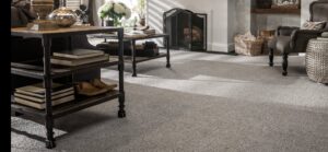 A spacious living room featuring newly installed light grey carpet by Great Northern Flooring in Bensenville, IL.