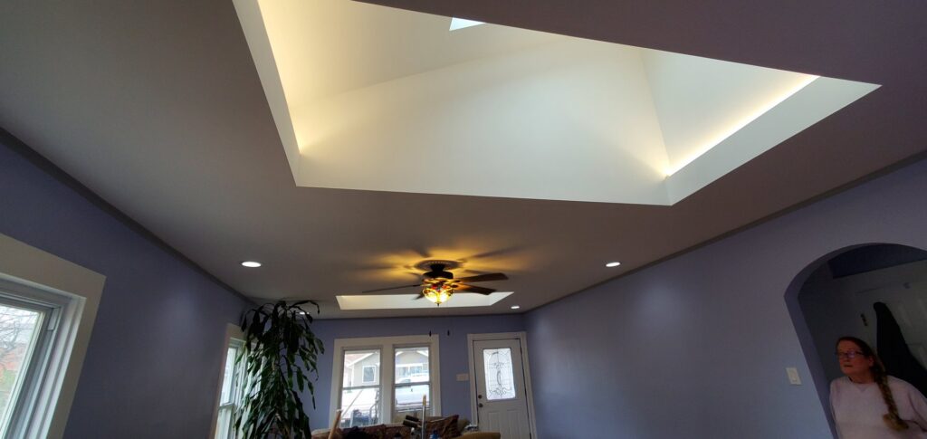 Living room with recessed lighting, ceiling fan, and illuminated skylight installed by Midway Electric Inc. in Columbia, MO.