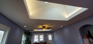 Living room with recessed lighting, ceiling fan, and illuminated skylight installed by Midway Electric Inc. in Columbia, MO.