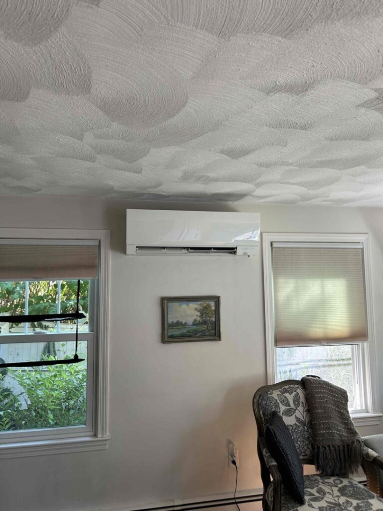 An indoor mini-split air conditioning unit installed in a living room by Heritage Home Service in Worcester, MA