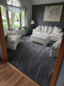A stylish living room featuring a dark grey patterned carpet installed by Rosas Carpet & Flooring in Shorewood, IL.