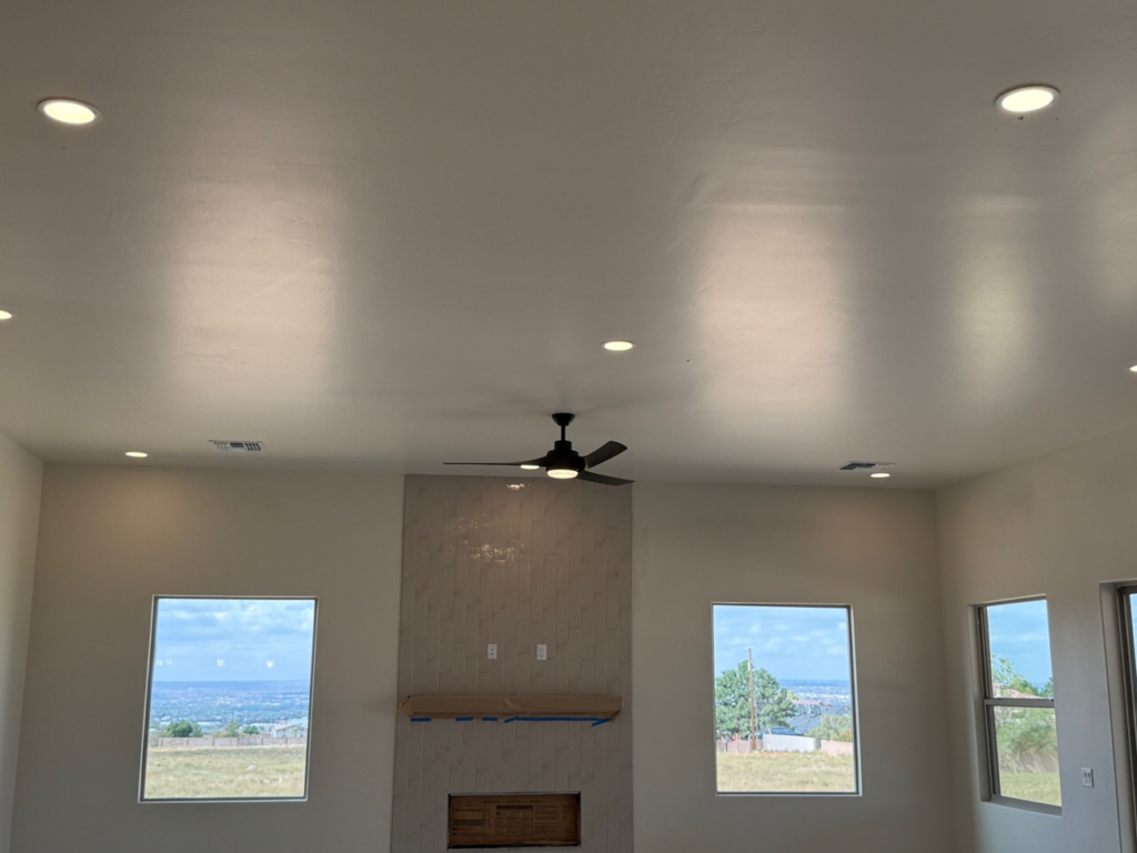 Living room with modern recessed lighting and ceiling fan installation by O'Dell Electrical Services in Albuquerque, NM.