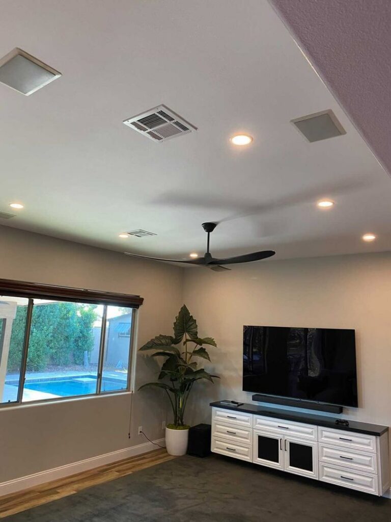Living room with modern recessed lighting and a ceiling fan installed by Pro Solutions Electric in Glendale, AZ.