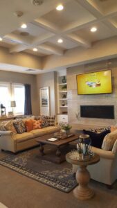 A living room with recessed lighting and a wall-mounted TV, showcasing electrical work by Safehouse Electric Company in Blue Springs, MO.