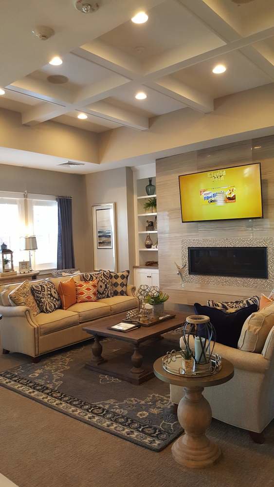 A living room with recessed lighting and a wall-mounted TV, showcasing electrical work by Safehouse Electric Company in Blue Springs, MO.