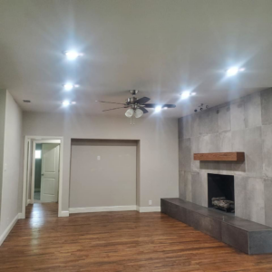 A spacious living room showcasing new recessed lighting and a ceiling fan installed by Triple JS & B Electric Inc. in Dallas, TX