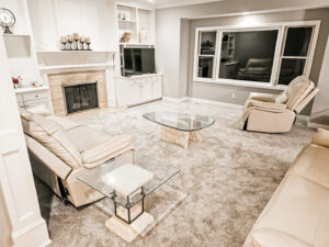 A cozy living room with a new light brown carpet installation by Absolute Floor Covering, Inc in Kentwood, MI.