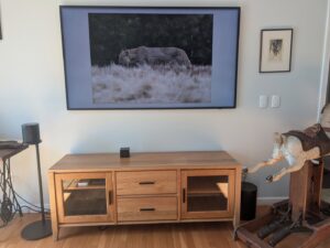 A living room with a large mounted TV and speakers installed by EPOS Systems, Inc. in West Springfield, MA.