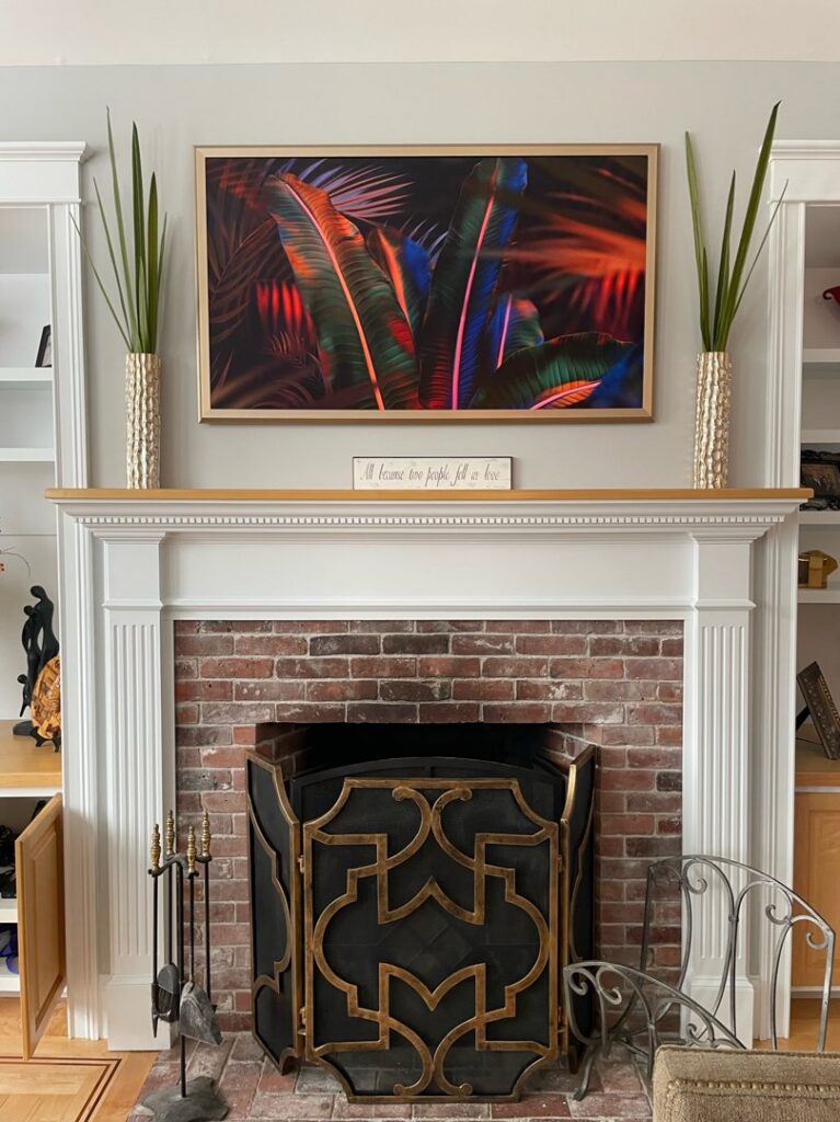 A living room TV mounted above a fireplace, installed by EPOS Systems, Inc. in West Springfield, MA.