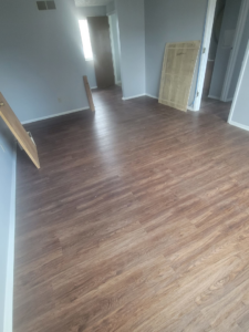 A spacious living room featuring new vinyl plank flooring installed by Harper's Floor's in Columbus, OH.