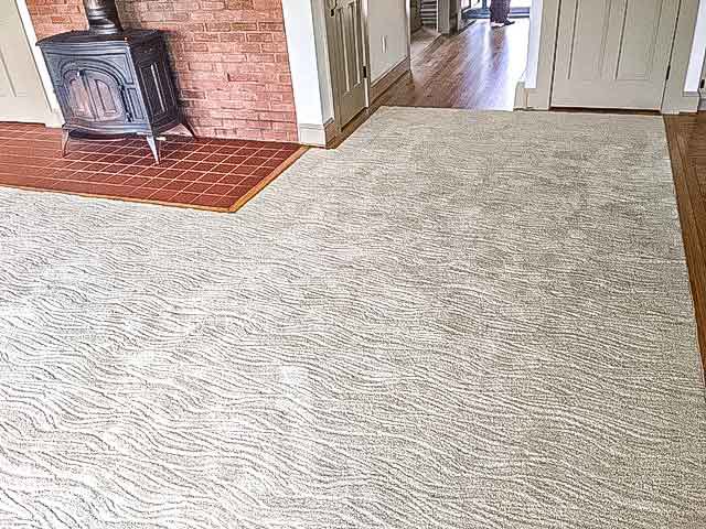 A cozy living room showcasing light-colored wall-to-wall carpeting installed by RugSale by Kaoud Rugs in West Hartford, CT.