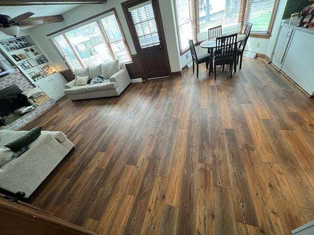 A spacious living room featuring a new wood-look flooring installation by VA Carpet Connection LLC in Chesapeake, VA.