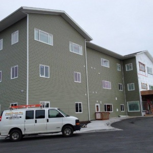 Local Electric Inc. service van parked outside a new building construction site in Kodiak, AK