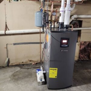 A Lochinvar water heater or boiler unit with piping installed by All The Way Heating & Cooling in Middleburgh, NY