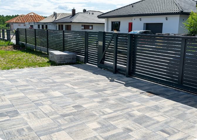 A long black horizontal slat fence with an integrated gate, installed by Coastline Gate Repair in Los Angeles, CA.