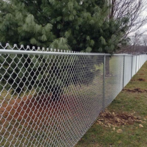 A long chain-link fence installed along a property line by Vanguard Fencing LLC in Lenexa, KS.