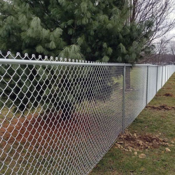 A long chain-link fence installed along a property line by Vanguard Fencing LLC in Lenexa, KS.