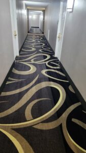 A long, clean hallway with patterned carpet, demonstrating the quality work of InnaCircle in Greensboro, NC.