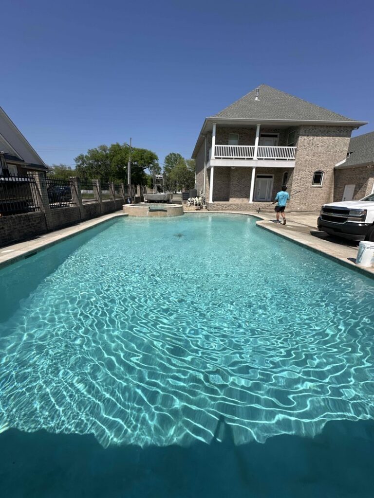 A long, clean swimming pool next to a residential home, reflecting the professional pool cleaning service by La Pool Pro LLC in New Orleans, LA.