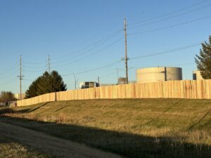 A long commercial wood privacy fence installed along a property line by Top Rail Fence Des Moines in West Des Moines, IA.