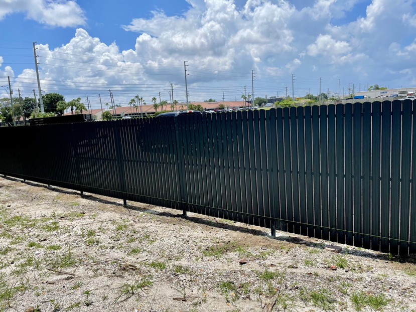 A long stretch of dark corrugated metal fence installed by New Euro Fences CA in Sacramento, CA.