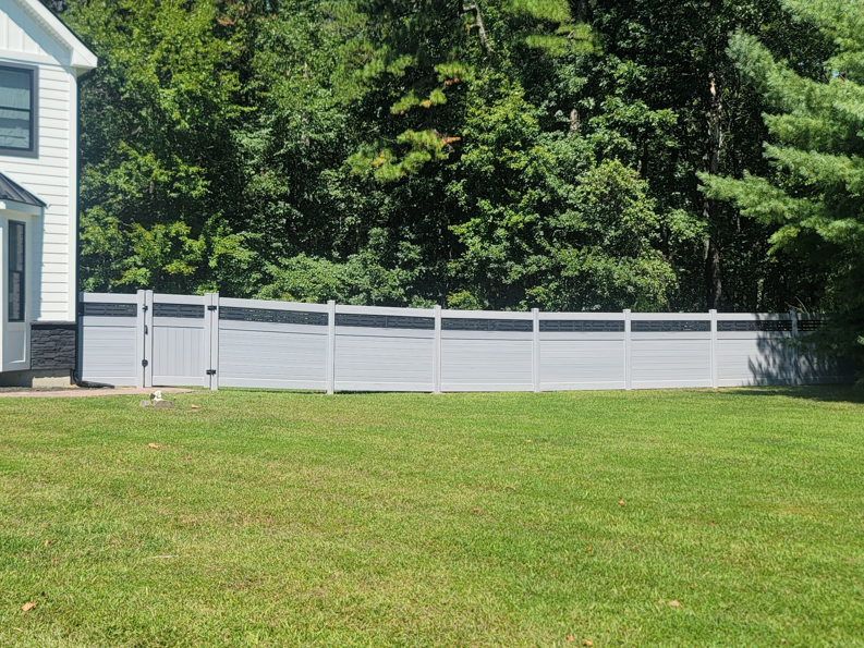 A long, modern grey horizontal privacy fence with black accents installed in a backyard by AllMasterfence in Toms River, NJ.