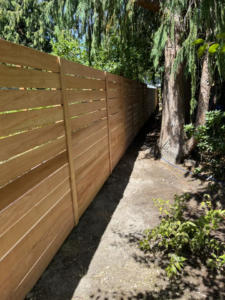 A long section of horizontal slat wood fence installed by Webb Fencing Pros in Seattle, WA.