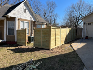 A long section of newly installed horizontal wood fence by Fence Solutions of NWA in Gravette, AR.