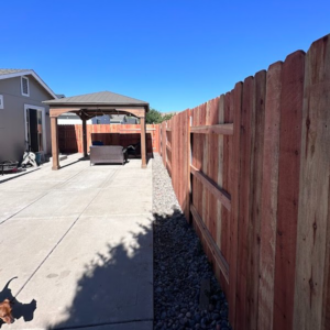 A long stretch of newly installed wooden privacy fence in a residential backyard by Mule Fence Inc. in Sparks, NV.