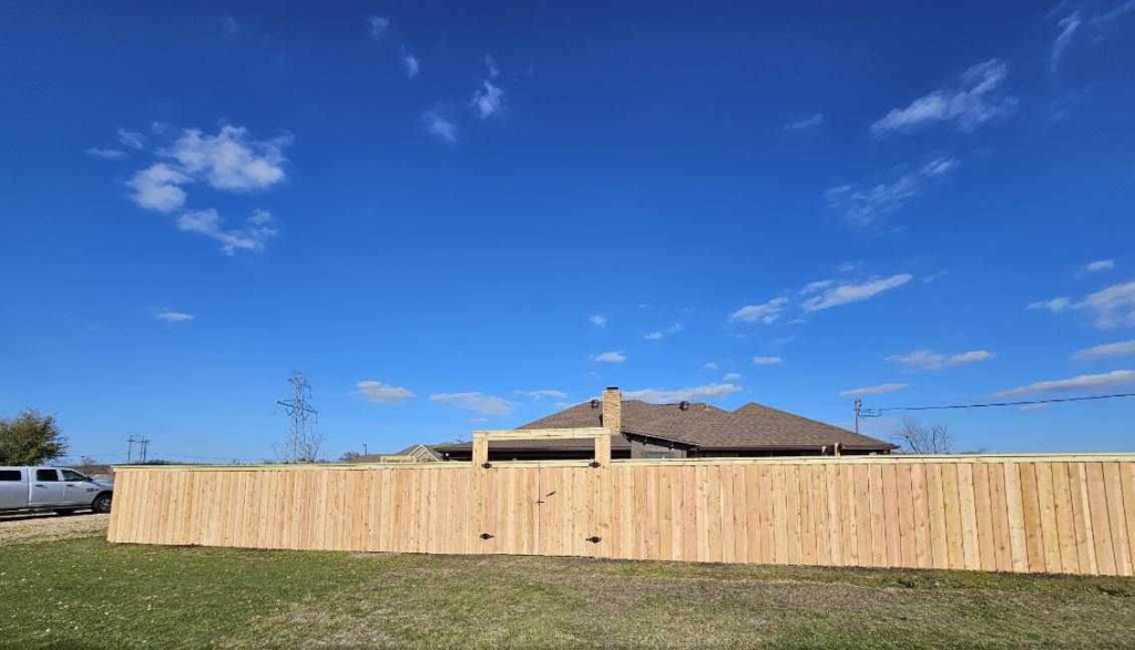 A long, newly installed wood privacy fence for a residential property by Straight Shot Solutions, LLC in Fort Worth, TX.