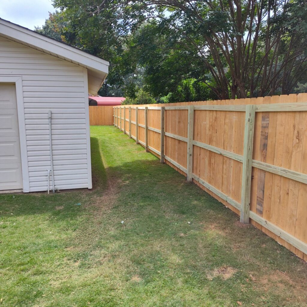 A long residential wood fence providing privacy and security, installed by The Fence Dudes in Birmingham, AL.