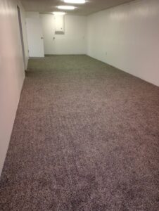 A long room featuring new brown carpet installation by Carpet Warehouse Lorain LLC in Lorain, OH.