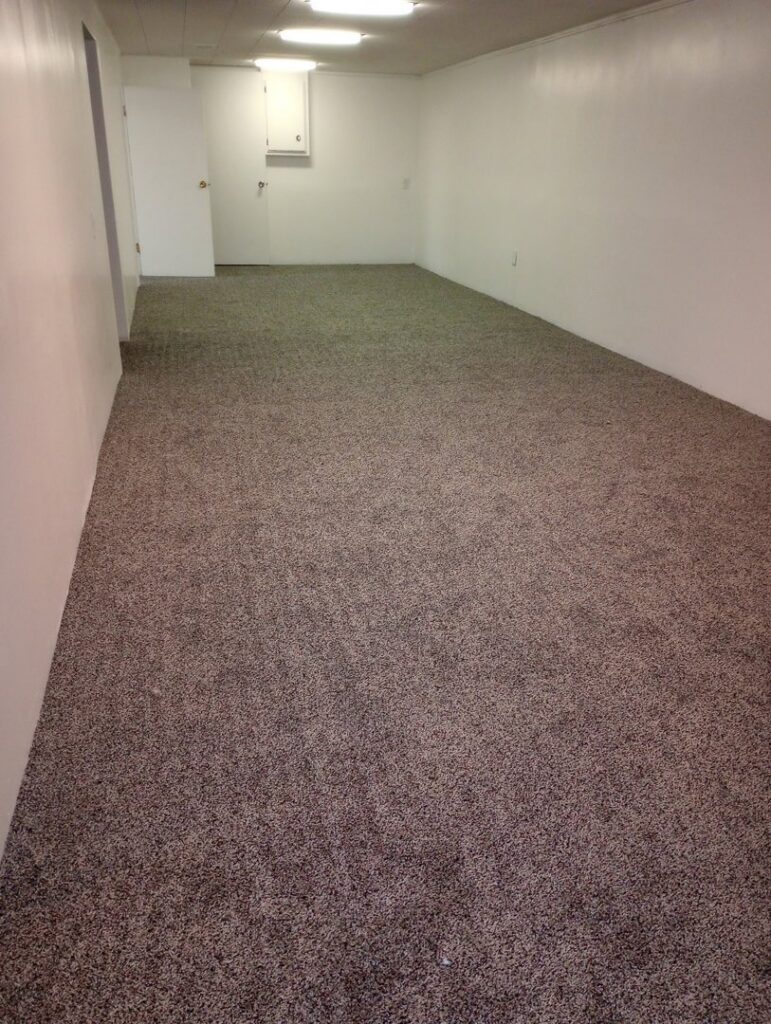 A long room featuring new brown carpet installation by Carpet Warehouse Lorain LLC in Lorain, OH.