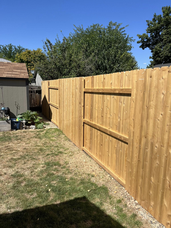 Long section of new wood privacy fence by Builders choice Fence, Deck & Patio Covers in Nampa, ID