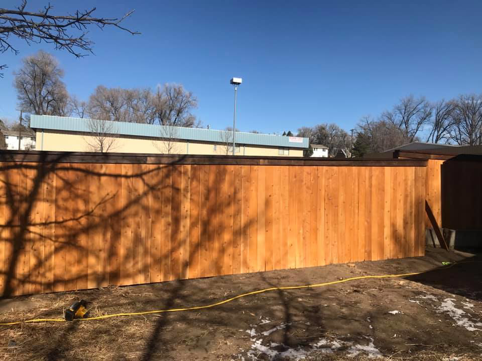 A long section of a newly installed wood privacy fence by Red Dirt Fencing and Woodwork, LLC in Fountain, CO.