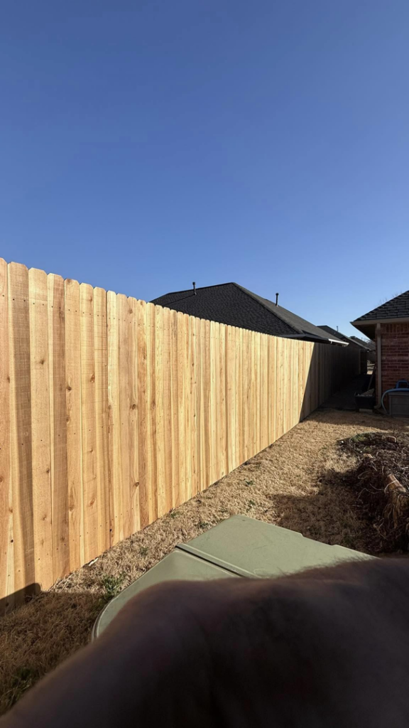 A long section of newly installed wooden privacy fence by On-Guard Fencing & Gates LLC in Oklahoma City, OK.