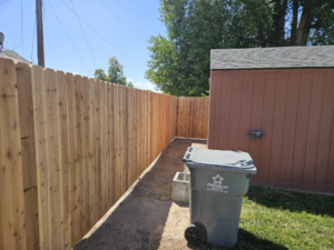A long section of a newly installed wood privacy fence running alongside a residential property by Regan Fencing & Services in Nampa, ID.