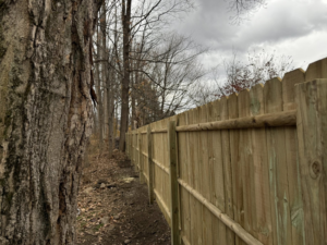 A long stretch of a newly built wood privacy fence installed by Red Lake Fencing & Construction in Springfield, MA.