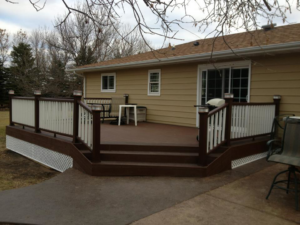 A long white three-rail farm fence stretching across a green field by Elite Custom Fencing in Arthur, IL.