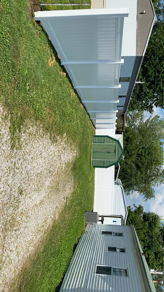 A long stretch of newly installed white vinyl fence by Higdon's fence install & repair in White Mills Junction, KY