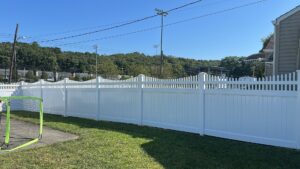 A long stretch of white vinyl fence installed by White Eagle Fence Inc in New Haven, CT.