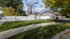 A long white vinyl privacy fence installed in a residential area by 208 Fence and Gate in Idaho Falls, ID.