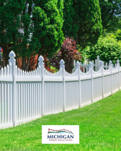A long white vinyl picket fence installed in a green lawn by Michigan Fence Solutions in Macomb, MI.