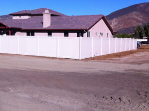 A long white vinyl privacy fence installed around a large property by All Around Fence Page in Imperial Beach, CA.